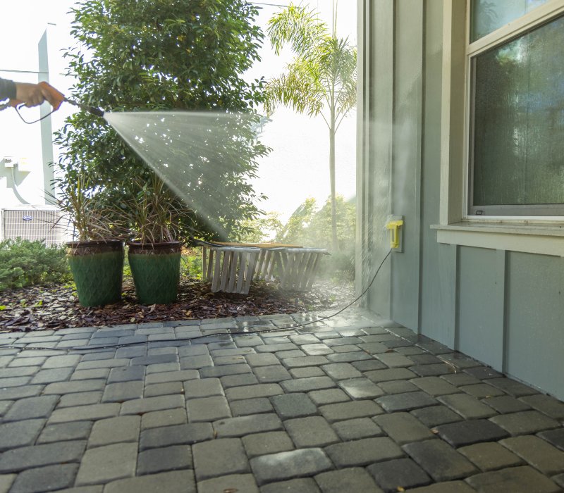 a power washer being used to clean a house exterior