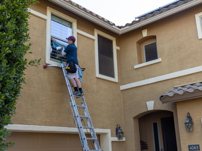 professional window cleaners using wipes and cleaning solution to clean the windows